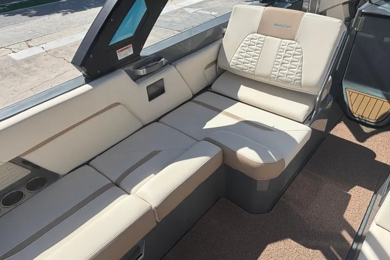 Slide: The Image of Luxurious seating in a 2022 MasterCraft X26 boat, featuring beige upholstery and modern design. - 10