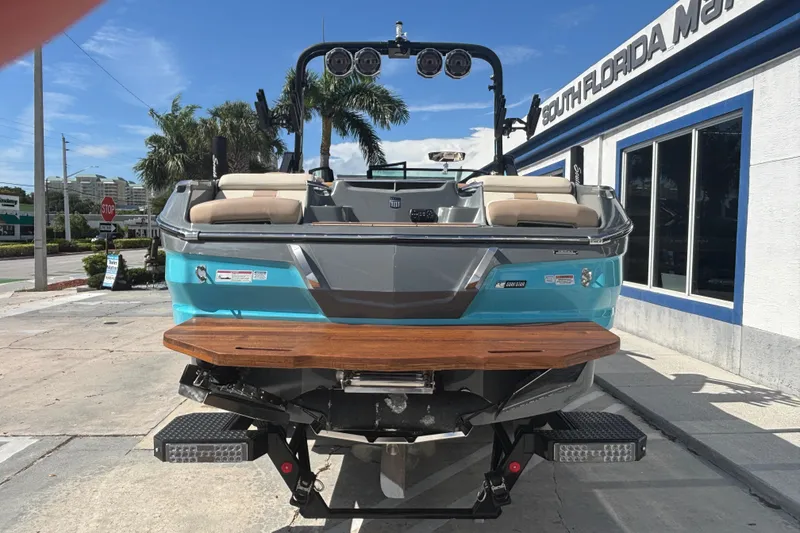 Slide: The Image of 2022 MasterCraft X26 boat displayed outdoors at South Florida dealership. - 2