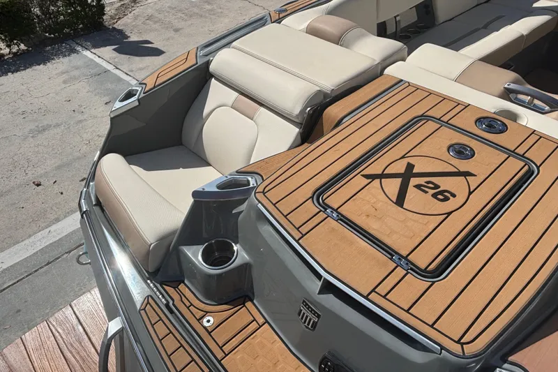 Slide: The Image of 2022 MasterCraft X26 boat interior with luxurious seating and teak flooring. - 3