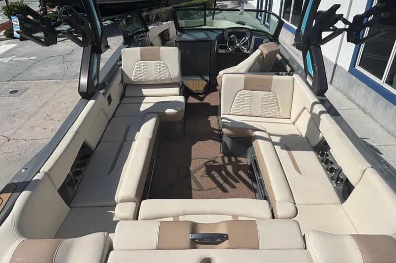 Slide: The Image of 2022 MasterCraft X26 boat interior with beige seating and modern design. - 4