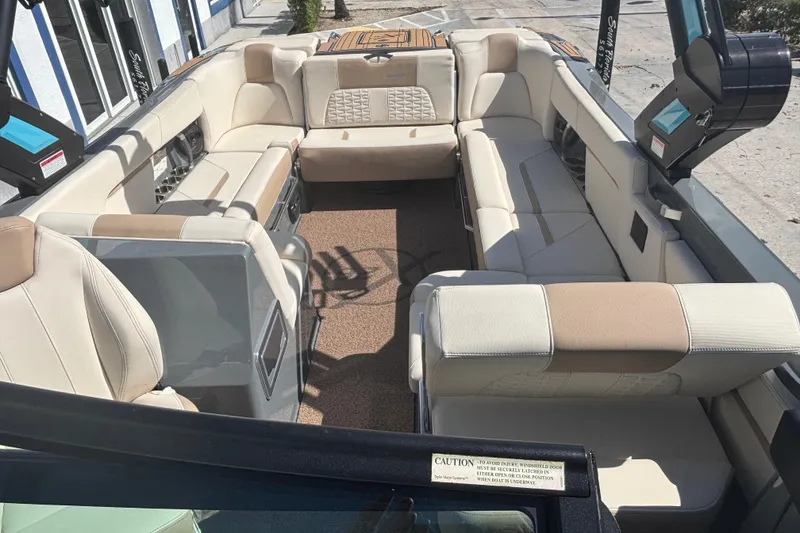 Slide: The Image of 2022 MasterCraft X26 boat interior with luxurious beige seating and modern design. - 8