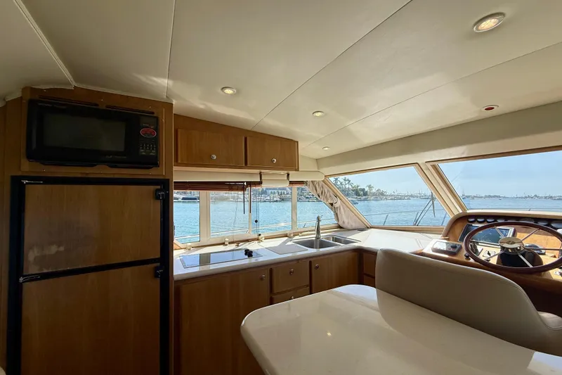 Slide: The Image of Interior of 2007 Navigator 44 Classic yacht with kitchen and helm, overlooking marina. - 19