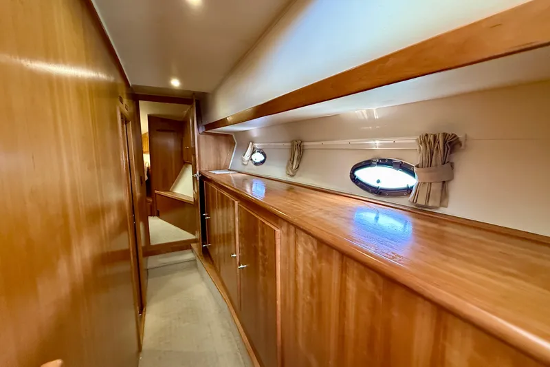 Slide: The Image of Luxurious wooden interior of 2007 Navigator 44 Classic yacht hallway with porthole windows. - 21