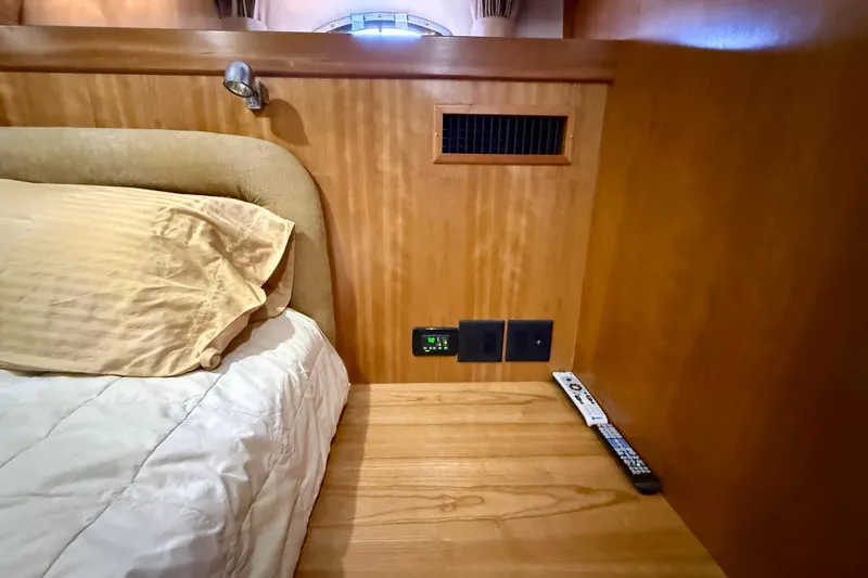 Slide: The Image of Cozy cabin interior of 2007 Navigator 44 Classic yacht with bed and wooden paneling. - 25