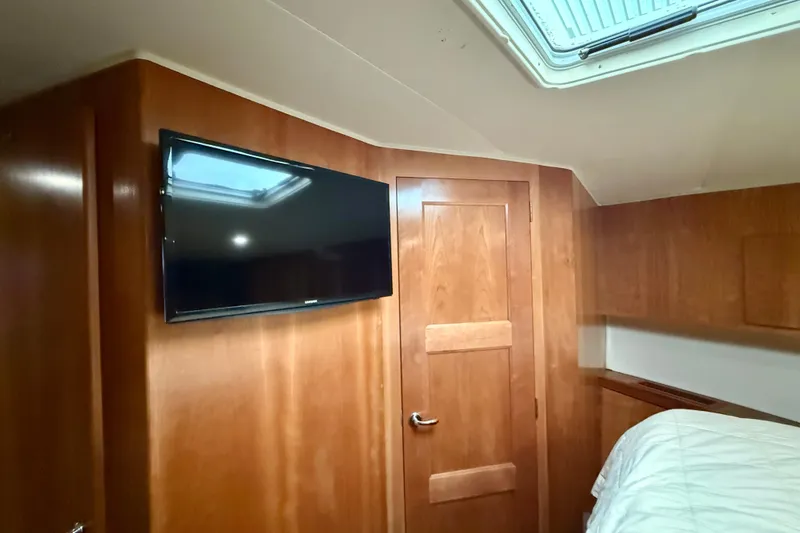 Slide: The Image of Interior of 2007 Navigator 44 Classic yacht with wood paneling and mounted TV. - 30