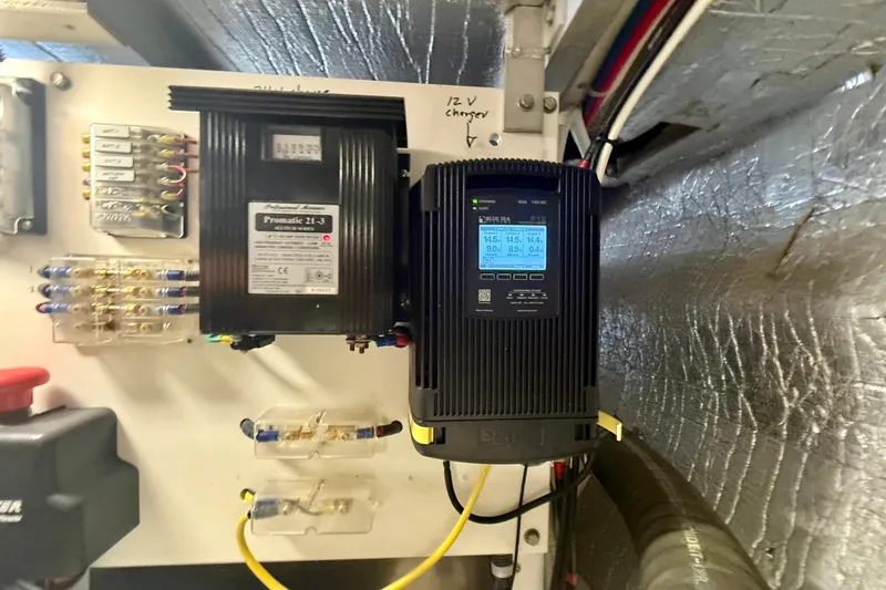 Slide: The Image of Electrical panel with chargers and wiring in a 2007 Navigator 44 Classic boat. - 40