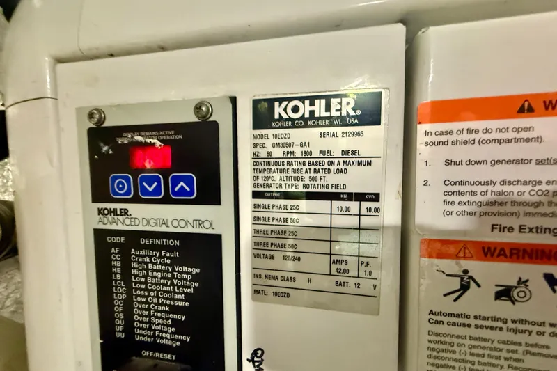 Slide: The Image of Kohler generator control panel with warning labels on a 2007 Navigator 44 Classic. - 41