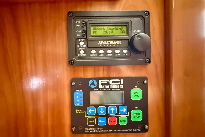 Slide: The Image of Control panels on a 2007 Navigator 44 Classic yacht, featuring Magnum Energy and FCI Watermakers systems. - 45