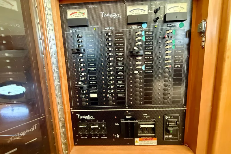 Slide: The Image of Electrical control panel of a 2007 Navigator 44 Classic yacht, featuring various switches and gauges. - 47