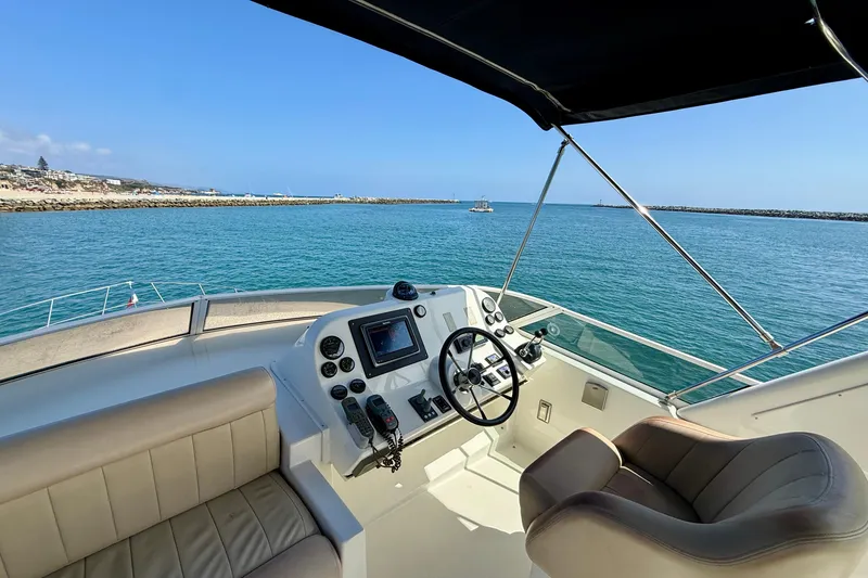 Slide: The Image of Helm of 2007 Navigator 44 Classic yacht overlooking serene ocean waters. - 48