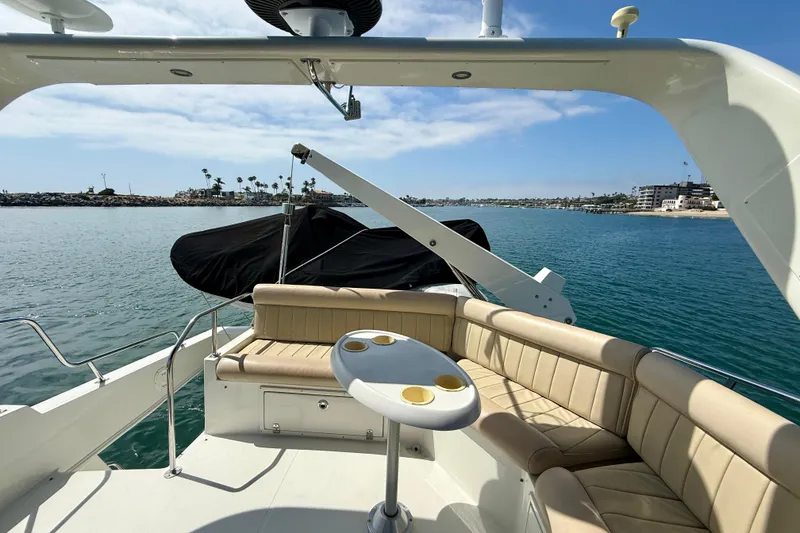 Slide: The Image of 2007 Navigator 44 Classic yacht deck with seating, table, and ocean view. - 52