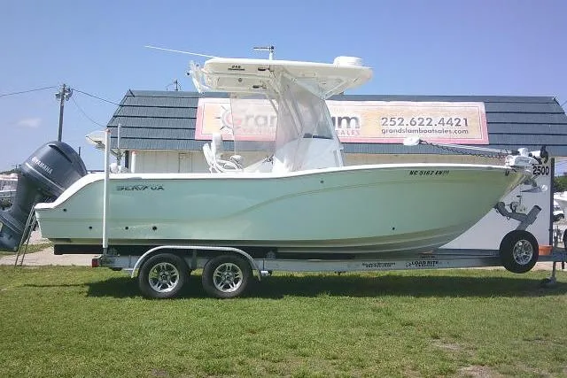 The Image of 2019 Sea Fox 248 Commander boat on trailer, parked outdoors near a building. - 1