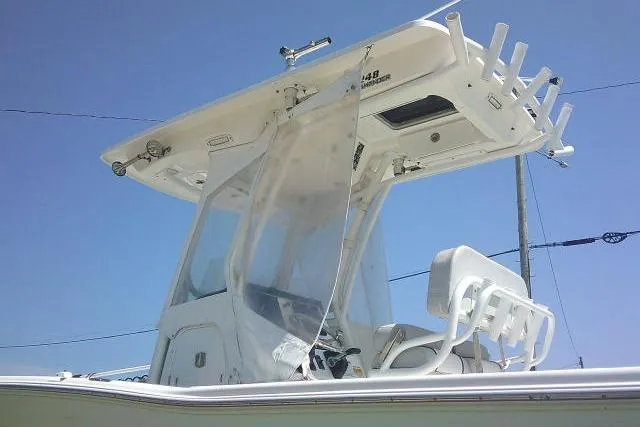 Slide: The Image of 2019 Sea Fox 248 Commander boat with T-top and rod holders under clear blue sky. - 14