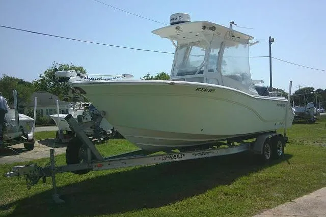 Slide: The Image of 2019 Sea Fox 248 Commander boat on trailer, parked on grass under clear sky. - 15