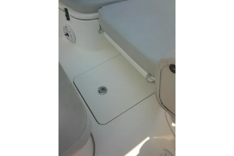 Slide: The Image of 2019 Sea Fox 248 Commander boat interior, featuring seating and storage compartment. - 24