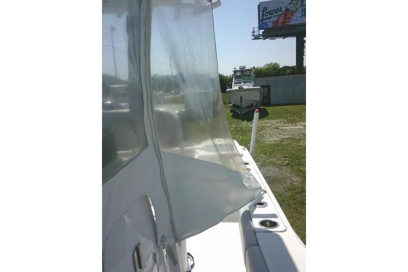 Slide: The Image of 2019 Sea Fox 248 Commander boat with clear enclosure, parked outdoors. - 29