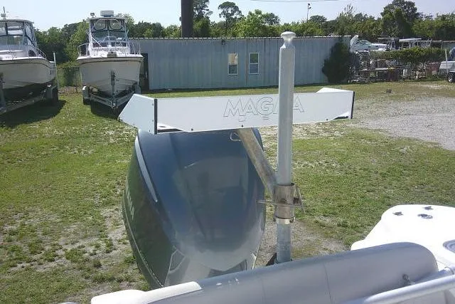 Slide: The Image of 2019 Sea Fox 248 Commander boat with Magma grill, parked outdoors near other boats. - 33