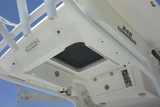Slide: The Image of 2019 Sea Fox 248 Commander boat interior, featuring control panel and hatch under clear blue sky. - 36