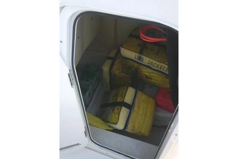 Slide: The Image of Storage compartment in a 2019 Sea Fox 248 Commander with life jackets and safety gear. - 37