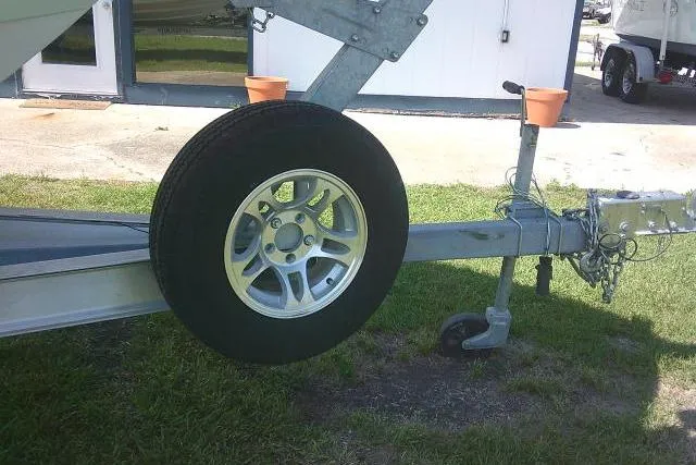 Slide: The Image of Trailer for 2019 Sea Fox 248 Commander boat with spare tire on grass. - 4