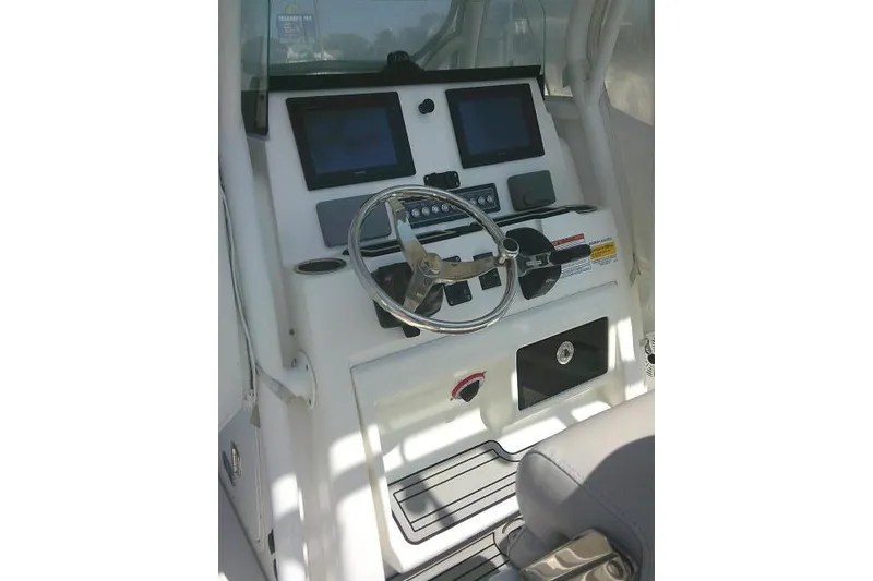 Slide: The Image of 2019 Sea Fox 248 Commander boat dashboard with steering wheel and dual screens. - 58