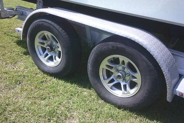 Slide: The Image of Trailer wheels of a 2019 Sea Fox 248 Commander boat on grass. - 6