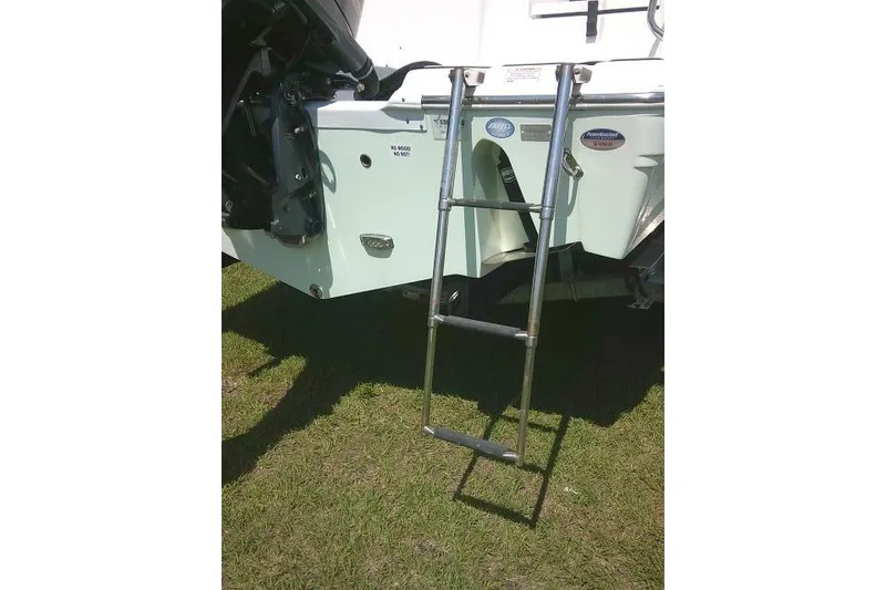 Slide: The Image of 2019 Sea Fox 248 Commander boat with a metal boarding ladder on grass. - 8
