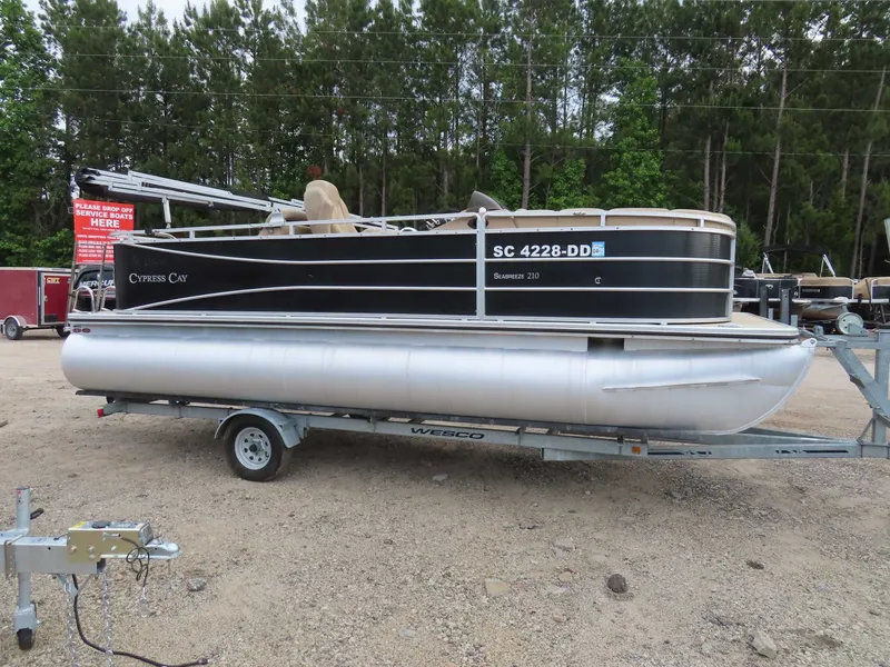 Slide: The Image of 2016 Cypress Cay SeaBreeze 210 Pontoon on trailer outdoors. - 2