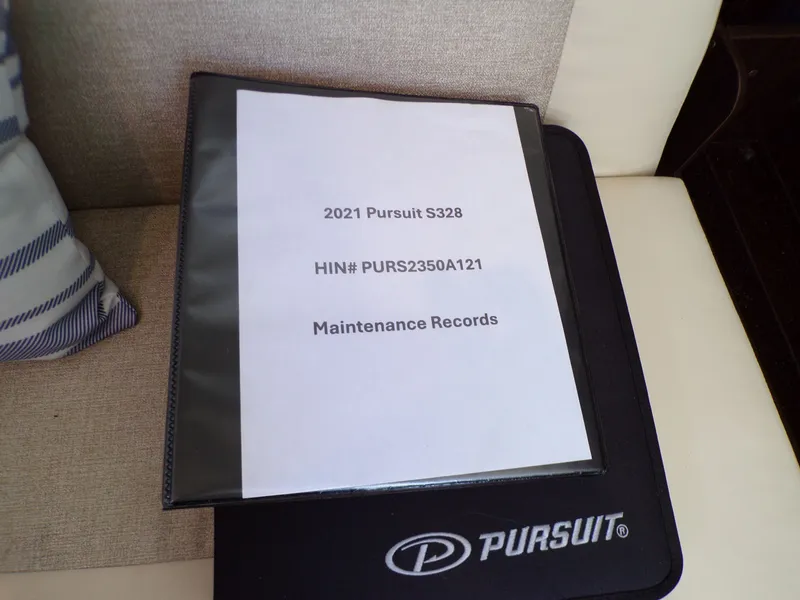 Slide: The Image of Maintenance records for a 2021 Pursuit S328 on a seat with cushions. - 32