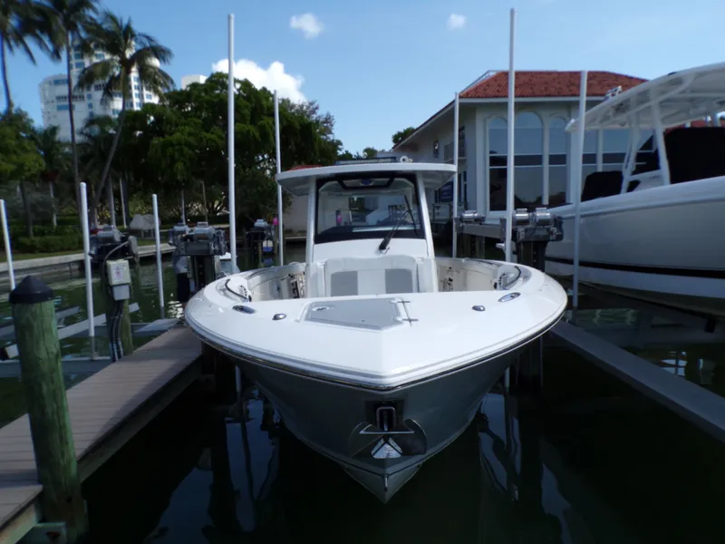 Slide: The Image of A 2021 Pursuit 328 Sport docked, featuring a sleek design and surrounded by water. - 49