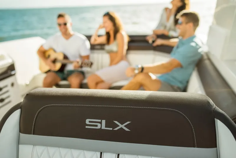 Slide: The Image of People relaxing on a 2016 Sea Ray SLX 310 boat. - 12