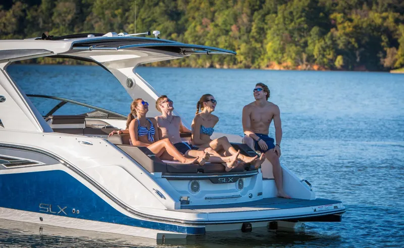 Slide: The Image of People relaxing on a 2016 Sea Ray SLX 310 yacht on a lake. - 26