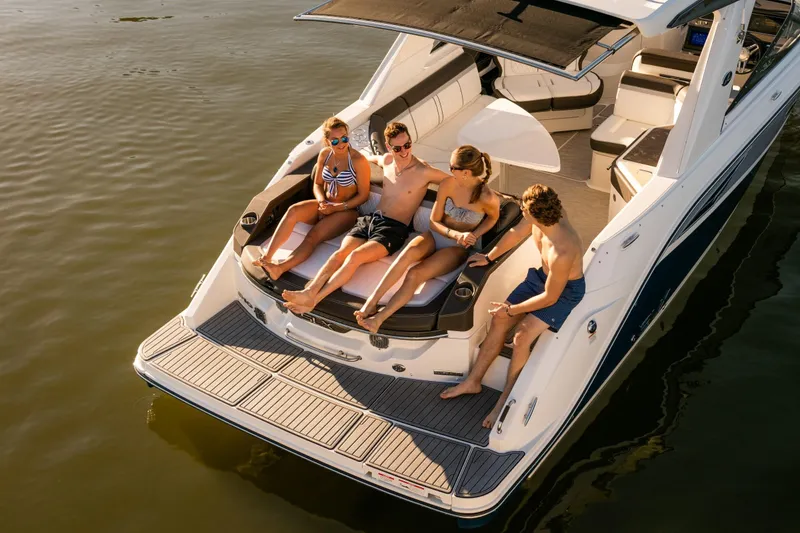 Slide: The Image of People relaxing on a 2016 Sea Ray SLX 310 yacht. - 27