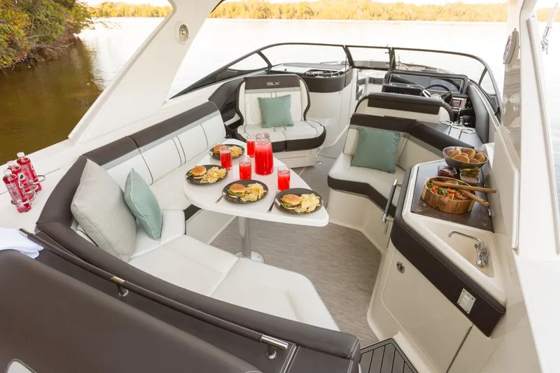 Slide: The Image of Luxurious interior of 2016 Sea Ray SLX 310 yacht with set dining table. - 33