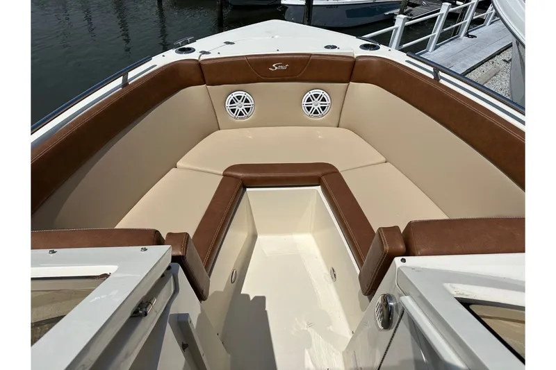 Slide: The Image of The 2021 Scout 235 Dorado features a cushioned seating area at the bow. - 28