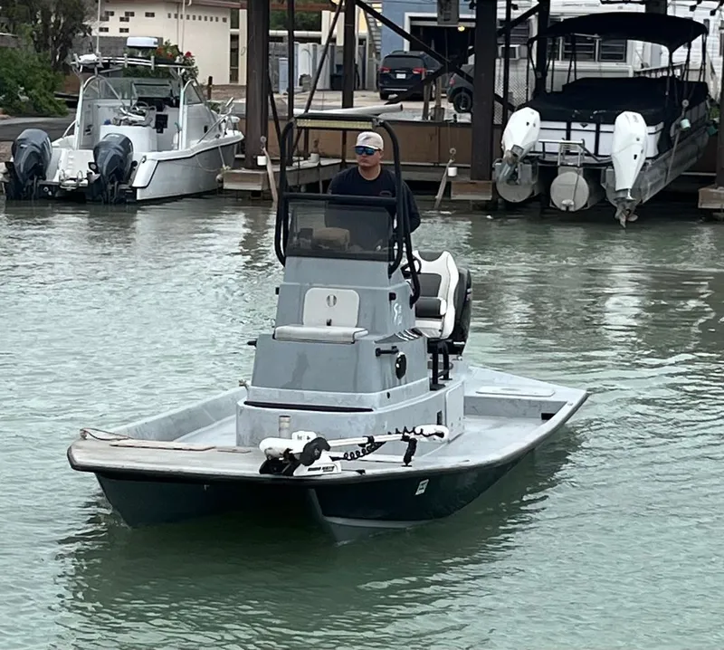 Slide: The Image of Shoalwater 21' Catamaran 2021 on water, with driver. - 2