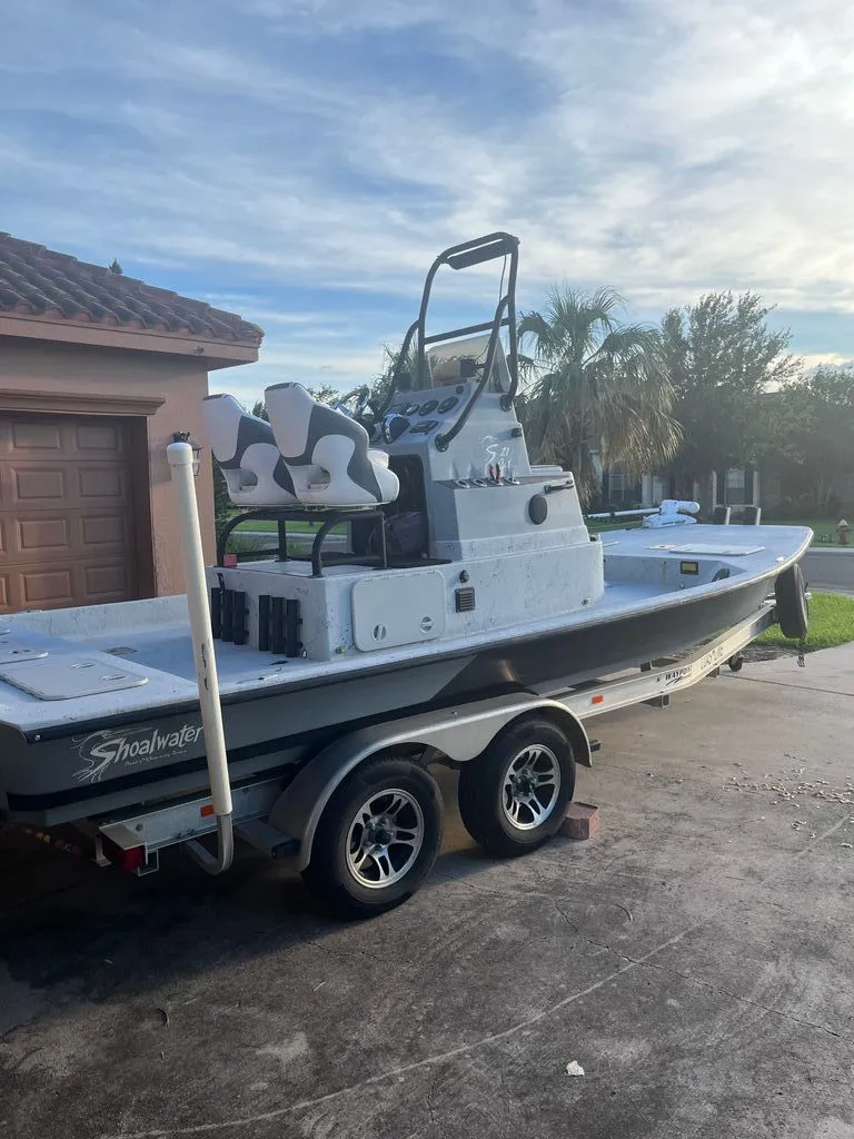Slide: The Image of 2021 Shoalwater 21' Catamaran on trailer in driveway. - 4