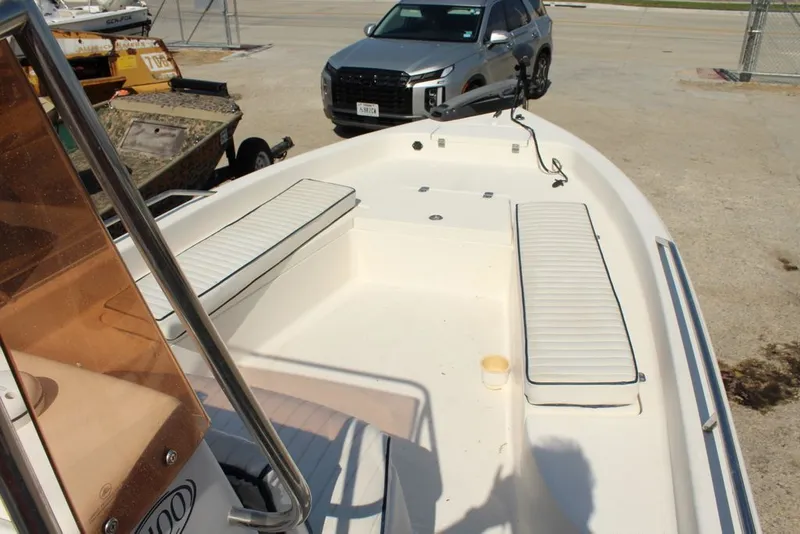 Slide: The Image of 2006 Clearwater 21CC boat with seating benches and car in background. - 2