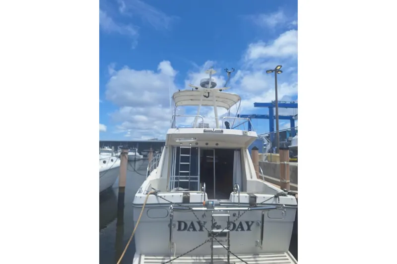 Slide: The Image of 1988 Birchwood 44TS yacht docked under a bright blue sky. - 2
