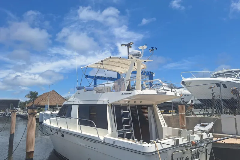 Slide: The Image of 1988 Birchwood 44TS yacht docked at marina under clear blue sky. - 3
