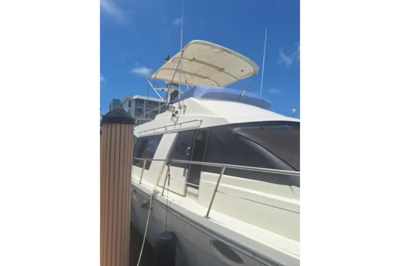 Slide: The Image of 1988 Birchwood 44TS yacht docked under clear blue sky. - 9