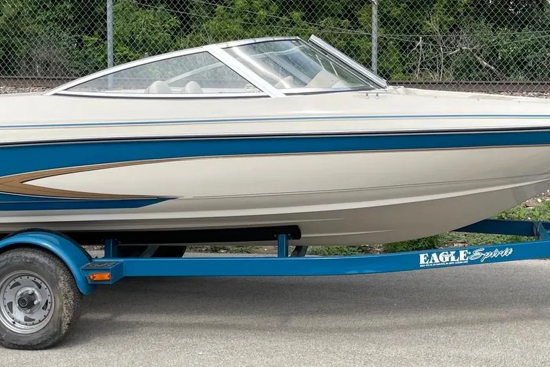Slide: The Image of 1995 Glastron SSV 175 boat on blue trailer, parked outdoors. - 1