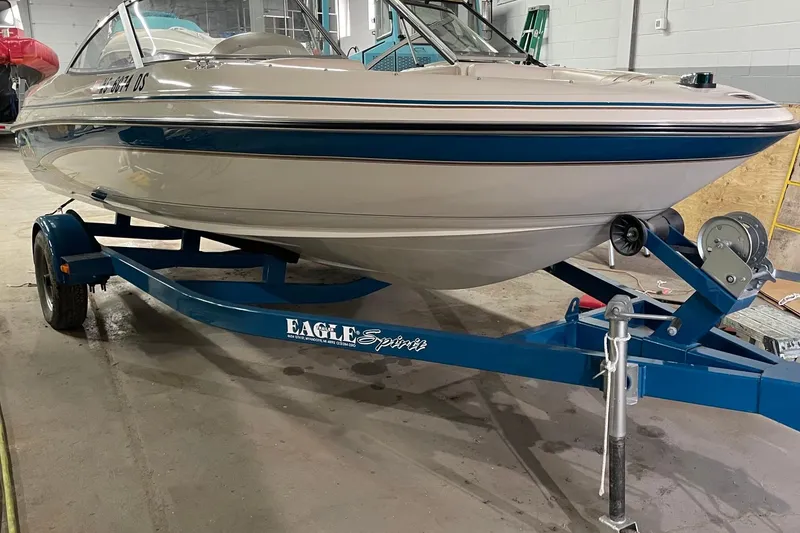 Slide: The Image of 1995 Glastron SSV 175 boat on blue Eagle Spirit trailer in garage. - 3