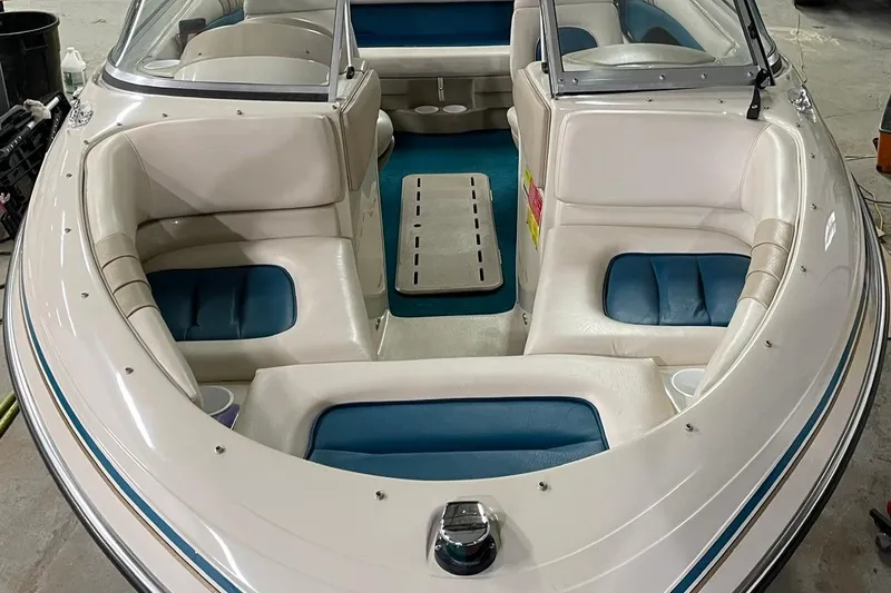 Slide: The Image of 1995 Glastron SSV 175 boat interior with white and blue seating, open bow design. - 4