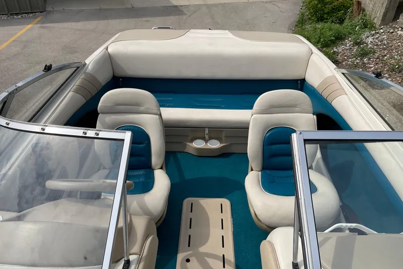 Slide: The Image of 1995 Glastron SSV 175 boat interior with blue and white seating, windshield, and cup holders. - 6