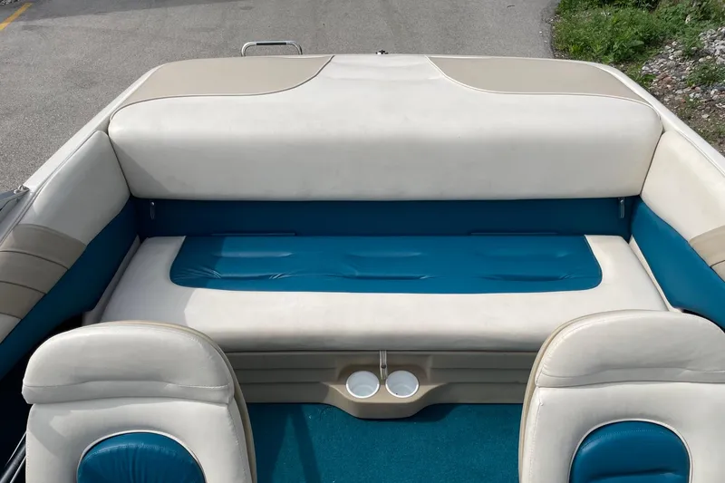 Slide: The Image of 1995 Glastron SSV 175 boat interior with blue and white seating and cup holders. - 7