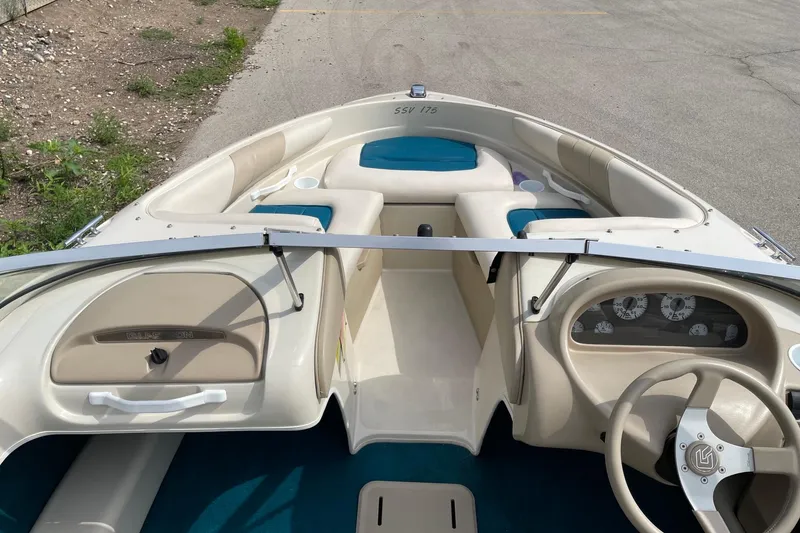 Slide: The Image of 1995 Glastron SSV 175 boat interior with beige and blue seating, steering wheel, and dashboard. - 9
