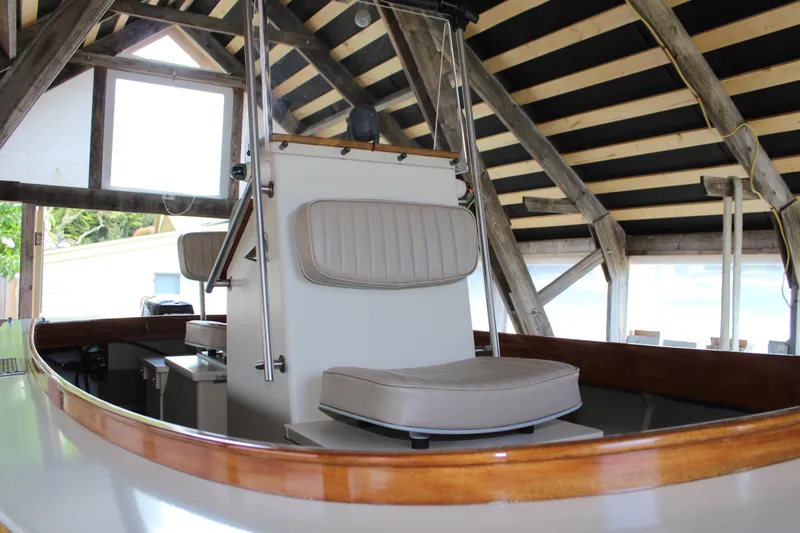 Slide: The Image of 2015 Custom Stambaugh Redwing 18' boat interior with cushioned seating and wooden accents. - 11