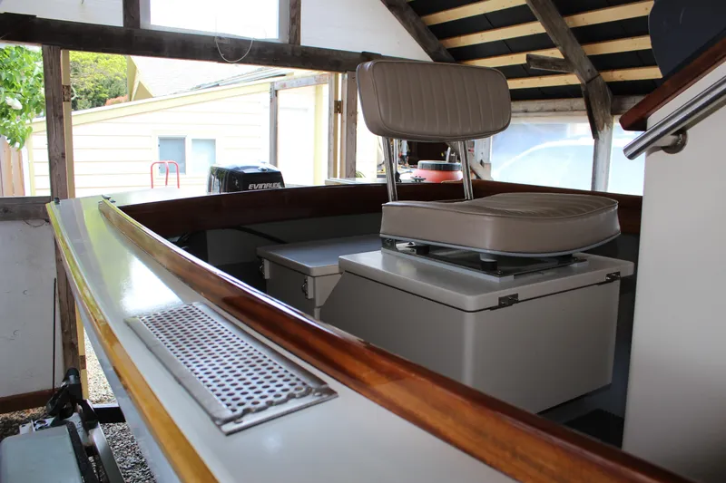 Slide: The Image of Custom Stambaugh Redwing 18' boat interior, featuring a swivel seat and Evinrude motor, 2015 model. - 12