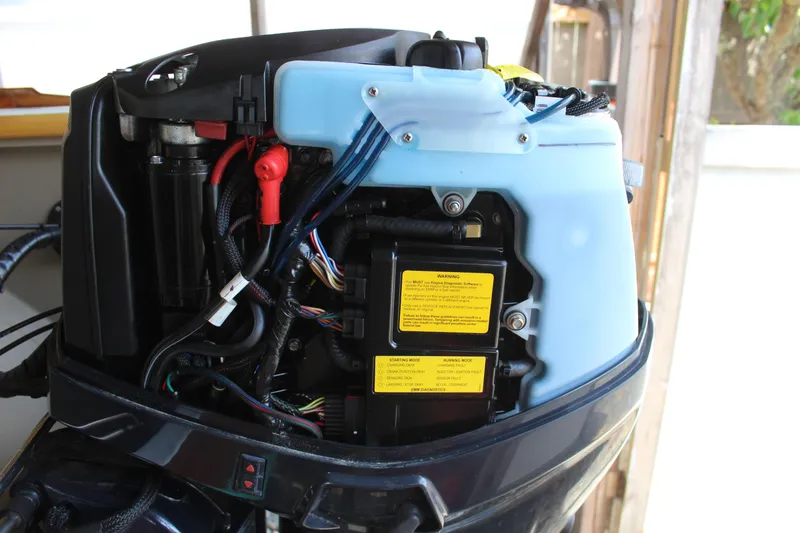 Slide: The Image of Close-up of a 2015 Custom Stambaugh Redwing 18' boat engine with visible wiring and components. - 15